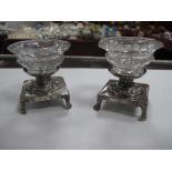 A Pair of XIX Century Continental Salts, each octagonal glass bowl loose set on square base raised