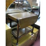 A 1920's Oak Tea Trolley, with fall leaves on chamfered legs.