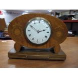 An Early XX Century Oak Oval Cased Mantel Clock, with ribbon inlay, on rectangular presentation