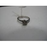 A Single Stone Diamond Ring, six claw set between knife edge shoulders.