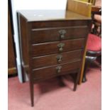 A XX Century Music Cabinet, with four fall front drawers, on square legs, including seventy-eight