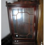 A Mahogany Hanging Corner Cupboard, astragal glazed door under dentil cornice.