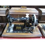 An Early XX Century CWS "Federation Family Machine" Sewing Machine, numbered 414838, in walnut case.