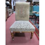 A XIX Century Nursing Chair, with a upholstered back and seat, on turned forefront legs.