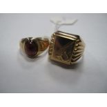 A Middle Eastern Gent's Ring, the square panel with horseshoe detail, between reeded shoulders,