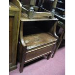 An XVIII Century Mahogany Commode, with a low back, shaped sides, on square legs.