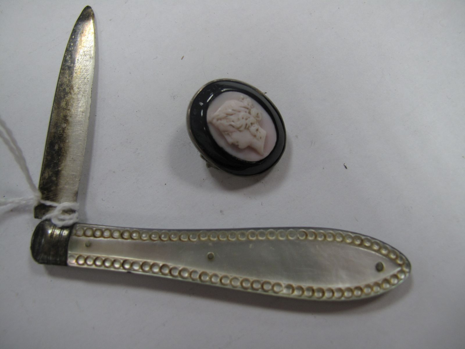 A Hallmarked Silver and Mother of Pearl Folding Fruit Knife, together with a XIX Century cameo