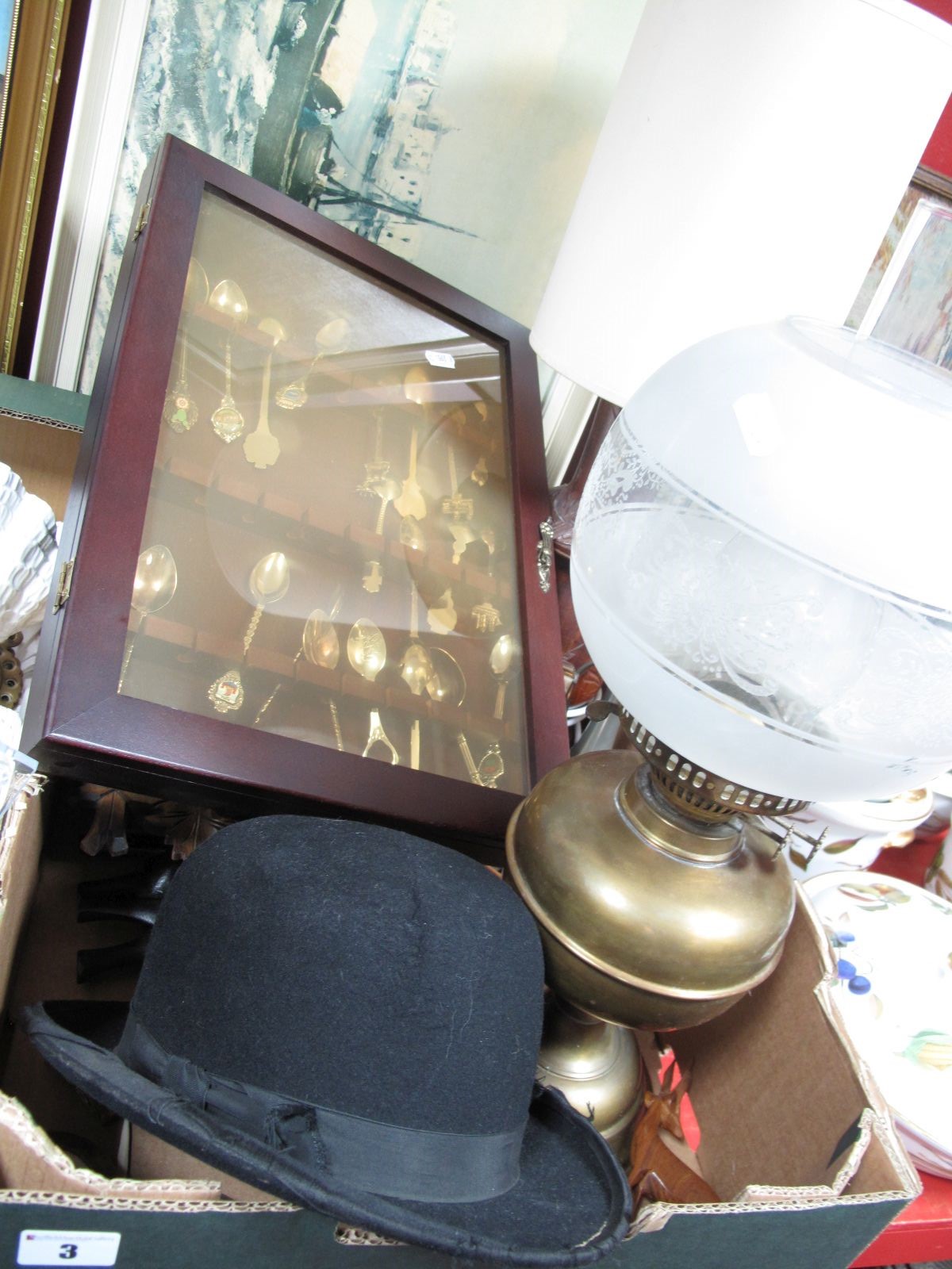 An Early XX Century Parafin Lamp, an Atlas Brand bowler hat, carved wooden cuckoo clock, metamec