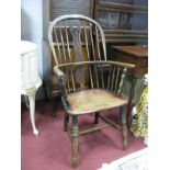 A XIX Century Ash and Elm Windsor Chair, with a hooped back, pierced splat, turned legs.