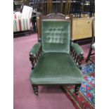 A Gent's Late XIX Century Walnut Armchair, with spindle arm supports, upholstered in a green velvet.