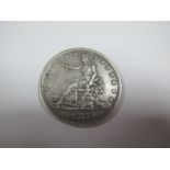 A United States Silver Trade Dollar, 1877, F but plugged.