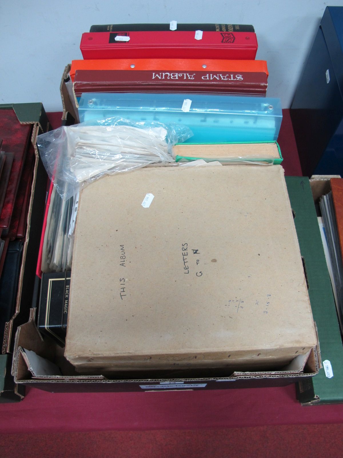 A Large Box of G.B and World Stamps, in eleven albums and stock books, loose and in packets. Some