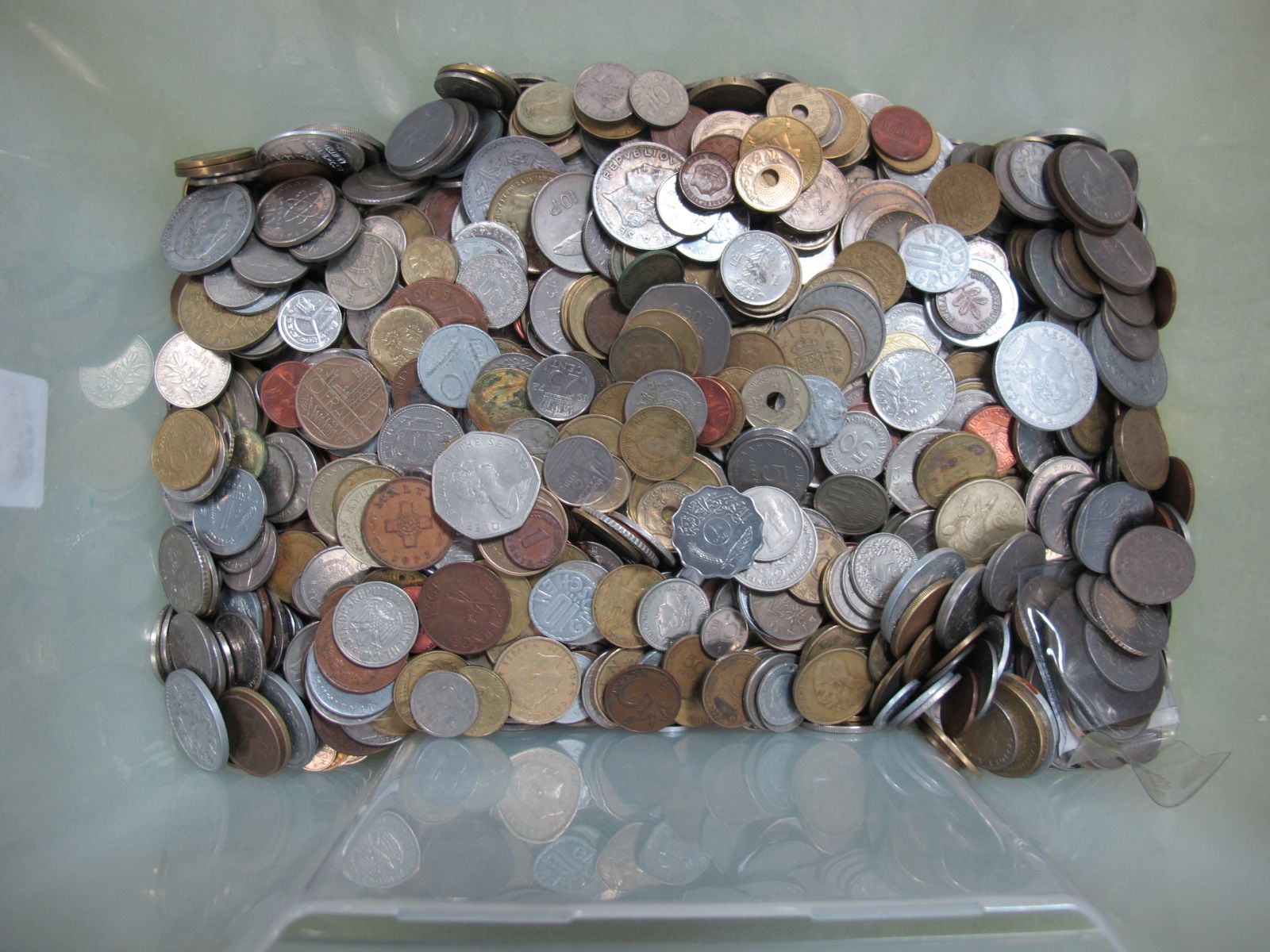 Approximately 9.0 Kgs of Mixed Foreign Coins, current and exchangeable coins noticed.