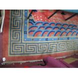 A Chinese Wool Carpet, with sinuous dragons on a rust red ground, within Greek key border,