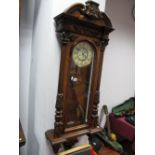 A XIX Century Walnut Cased Viennese Wall Clock, with twin weights, cream dial and split Corinthian