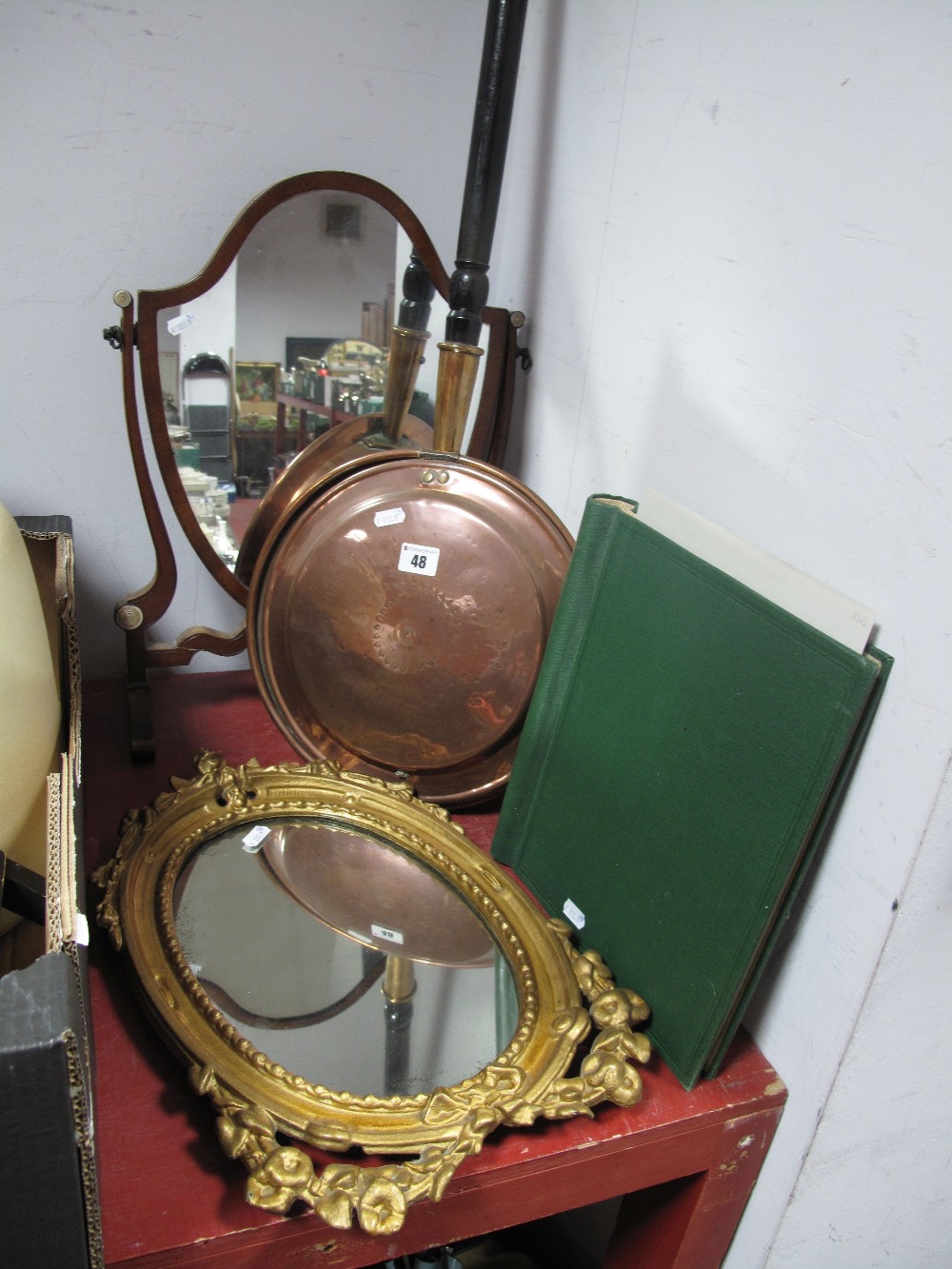 An Early XX Century Mahogany Toilet Mirror, shield mirror, shaped and scrolled supports and feet,