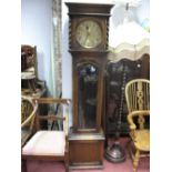 A 1920's Oak Cased Twin Weight Driven Grandfather Clock, brass dial, Arabic numerals, the hood