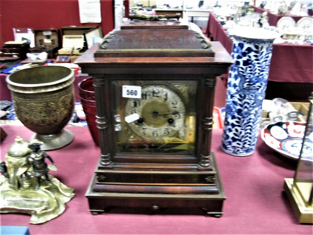 An Early XX Century Mantel Clock, the pediment with a carrying handle, brass silvered dial, on a