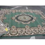 A Smirna Synthetic Rug, with allover floral decoration on olive green ground, approximately 326 x