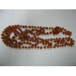 A Long Single Strand Faceted Amber Coloured Bead Necklace.