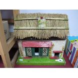 A Small Mid XX Century Dolls House, in the form of a thatched cottage.