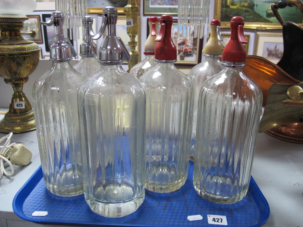 Seven Mid XX Century Etched Advertising Soda Syphons, three with chrome dispensers.