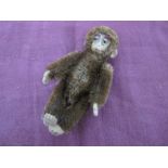 An Original Miniature Monkey by Schuco, jointed head, arms and legs, 8.5cm high.