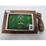 An R.A.F. Sweethearts Badge, other miniature aeroplanes, framed; together with a carved clenched