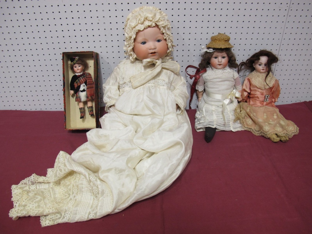 An Armand Marseilles Baby Doll, plus three other bisque headed dolls. Two with signs of cracks to