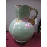 A XIX Century Bulbous Shaped Jug, with gilt highlights, light green ground, the handle in the form