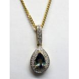 An 18ct Gold Brazilian Alexandrite and Diamond Set Pendant, of pear shape, on elongated bale, on