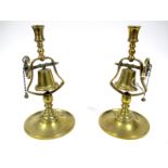 A Pair of XIX Century Brass Tavern Candlesticks, the columns with a swinging bell on a wheel