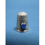 Charles Horner; A Hallmarked Silver Thimble, Chester 1905, with applied blue heart shape cabochon.