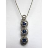 A 9ct White Gold Sapphire and Diamond Set Triple Cluster Drop Pendant, composed of three uniform