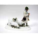 An Early/Mid XX Century German Porcelain Model of a Shepherd Standing Knitting Beside Three Sheep,