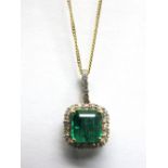 An 18ct Gold Zambian Emerald and Diamond Cluster Pendant, square four claw set to the centre, within