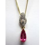 An 18ct Gold Shimoyo Rubellite and Diamond Set Pendant, elongated pear shape four claw set, below