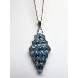 A 9ct White Gold Aquamarine Set Pendant, of elongated tapering design, oval claw set throughout,