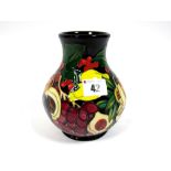A Moorcroft Pottery Vase, of baluster form, painted in the Figgy Pudding pattern, designed by Emma