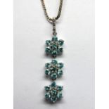 A 9ct White Gold Apatite and White Sapphire Set Triple Cluster Drop Pendant, of flowerhead design,