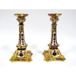 A Pair of Royal Crown Derby Porcelain Old Imari 1128 Candlesticks, the tapered columns raised on
