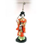 A Mid XX Century Japanese Porcelain Table Lamp, modelled as a Geisha holding a lantern and a fan,