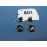 A Pair of Sapphire Set Drop Earrings, each composed of claw set surmount suspending larger claw