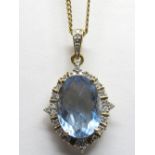 A 9ct Gold Fluorite and Diamond Set Pendant, oval four claw set to the centre, within shaped