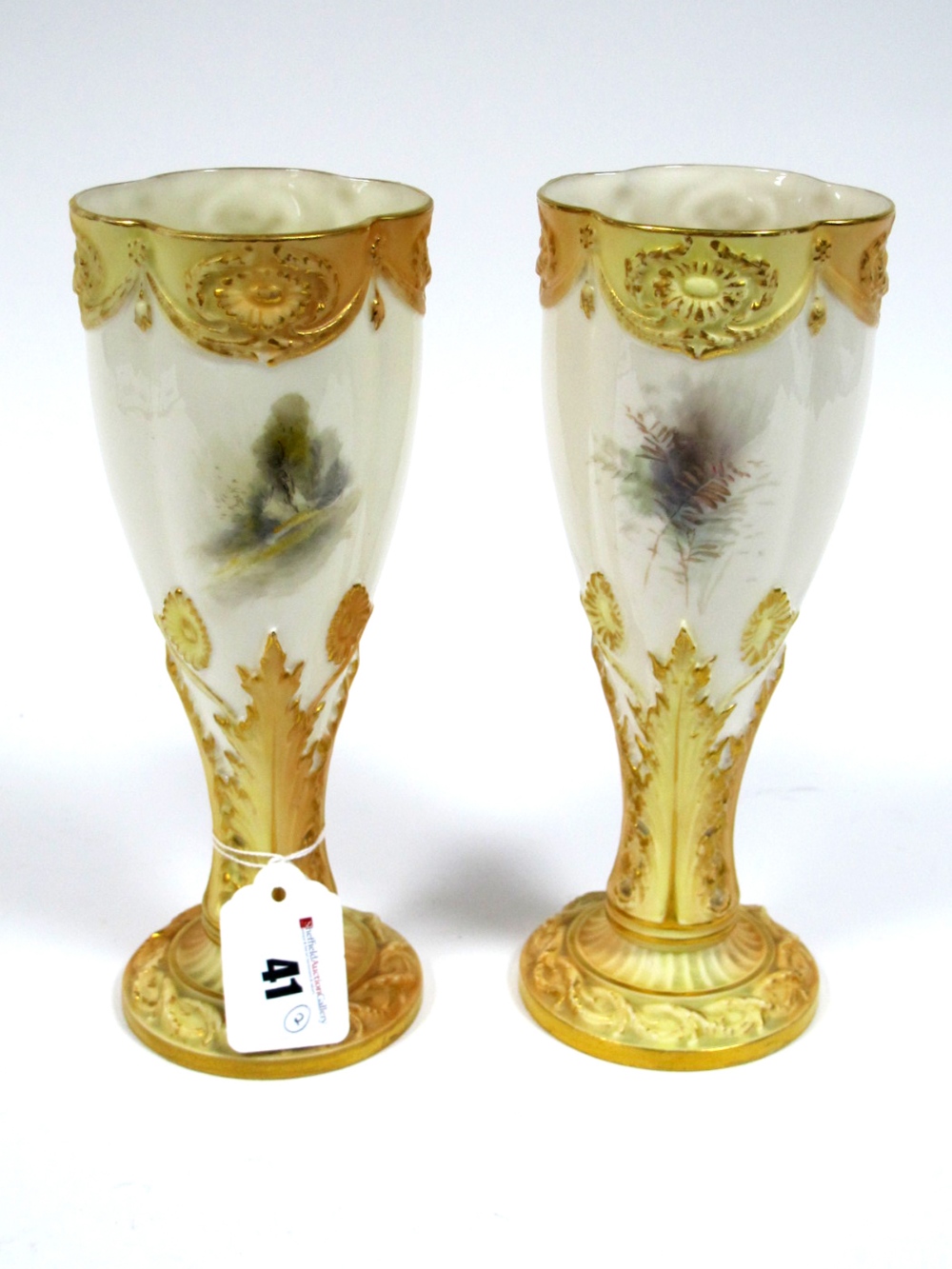 A Pair of Royal Worcester Porcelain Vases, of elongated lobed form raised on leaf moulded blush