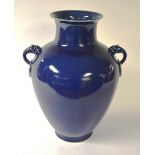 A large Chinese blue glazed vase, with dragon finials to either side, character marks to base,