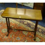 A Victorian mahogany side table, the rectangular top raised on turned columns,