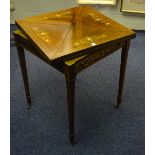 An Edwardian rosewood envelope card table, the swivel top enclosing green felt lined interior,