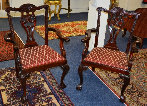 A pair of Chippendale style carver armchairs, raised on cabriole and ball and claw supports,