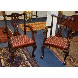 A pair of Chippendale style carver armchairs, raised on cabriole and ball and claw supports,